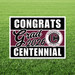 Black and white yard sign with maroon center stripe featuring "CONGRATS Grad 2026 CENTENNIAL" text and Centennial Patriots logo on green grass background.