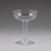 Clear plastic champagne coupe glass with a wide bowl, tall stem, and broad base, shown against a neutral gray background.