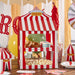 Red and white striped cardboard circus tent with "Welcome to the Circus" banner, displaying donuts, layered cake, and popcorn in window compartments.
