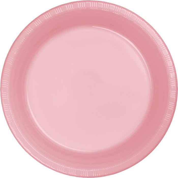 Pink disposable plastic plate with a ridged rim and shallow well, shown from above against a white background.