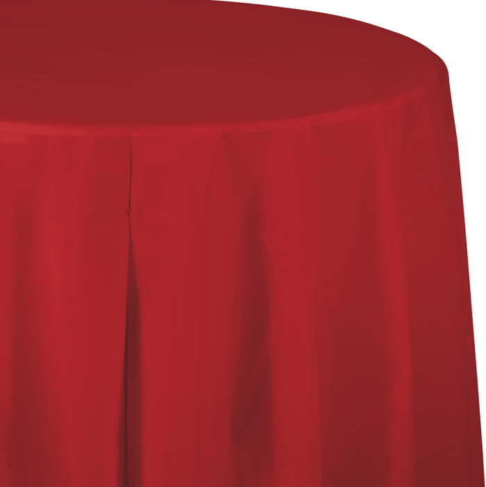 Bright red round tablecloth with deep draping folds cascading down the sides, shown from an angled perspective displaying the fabric's smooth texture and generous coverage.