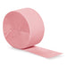Roll of pink crepe paper streamer partially unrolled against a white background.