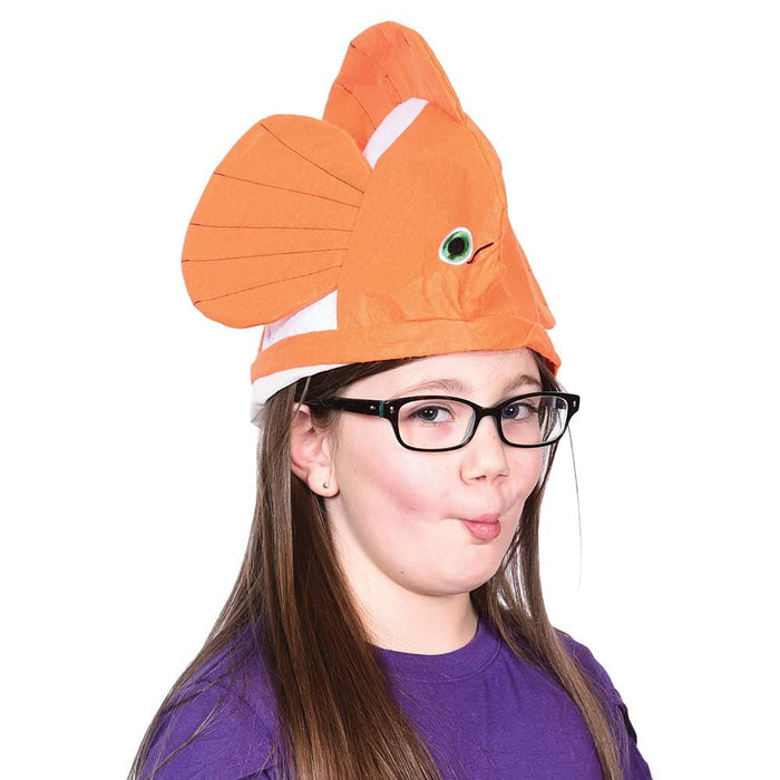 Bright orange fabric fish-shaped hat with white belly stripe, green eye detail, and fanned tail fin, worn by a person with long brown hair and glasses.