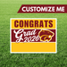 Graduation-themed sign with 'Congrats Grad 2026' on a grass background