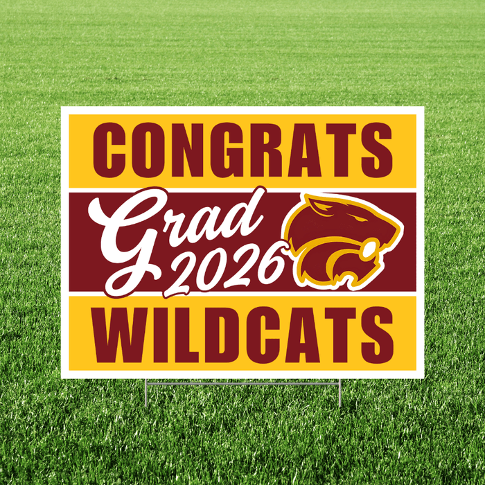 Yellow and maroon yard sign with "CONGRATS Grad 2026 WILDCATS" text and a wildcat head logo on green grass background.