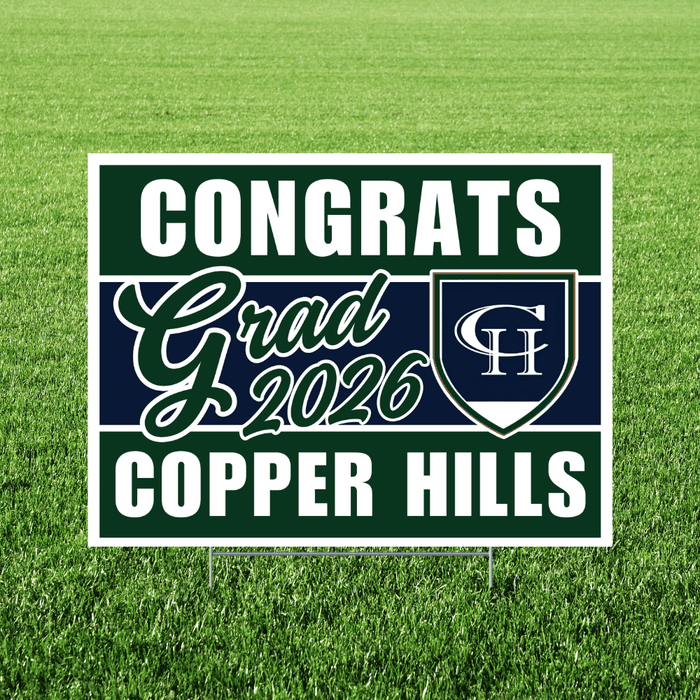 Green and navy yard sign with white text reading "Congrats Grad 2026" and "Copper Hills" with a shield logo, displayed on grass.