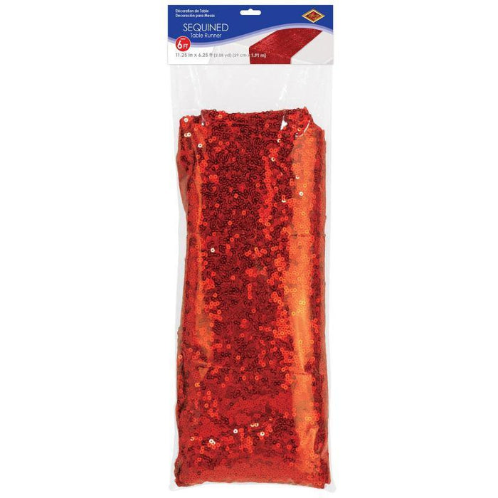 Red sequined table runner with shimmering sparkle finish displayed in clear packaging with blue header label showing product dimensions.