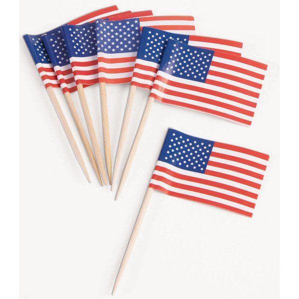 Six small American flags with blue canton sections, red and white stripes, and wooden picks arranged in a fan display on white background.