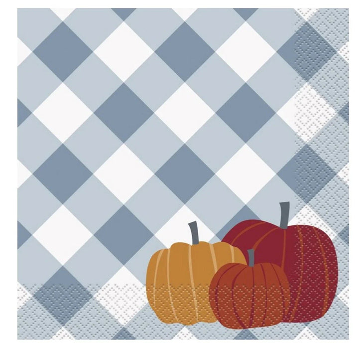 Blue and white gingham patterned napkins with an orange pumpkin and red apples illustrated in the corner.