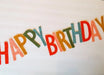 Colorful felt banner strung across white background with staggered letters spelling "Happy Birthday" in red, orange, yellow, green, and blue.