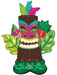Colorful inflatable tiki mask balloon featuring a brown wooden face with pink and teal stripes, white teeth, tropical feather headdress, and green leaf-shaped wings with pink flowers.