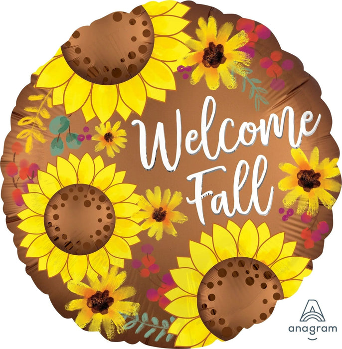 Round brown satin balloon decorated with bright yellow sunflowers, smaller yellow flowers, and colorful berries on a brown background with white "Welcome Fall" text.