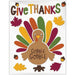 Colorful Thanksgiving gel cling decal featuring a brown turkey with "Gobble Gobble" text on its belly, surrounded by multicolored feathers, autumn leaves, and acorns with "Give Thanks" text at the top.