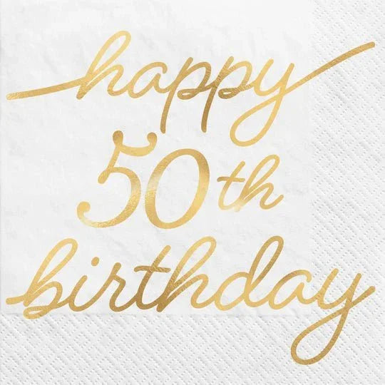 White beverage napkin with gold script text reading "happy 50th birthday" and decorative gold lines.