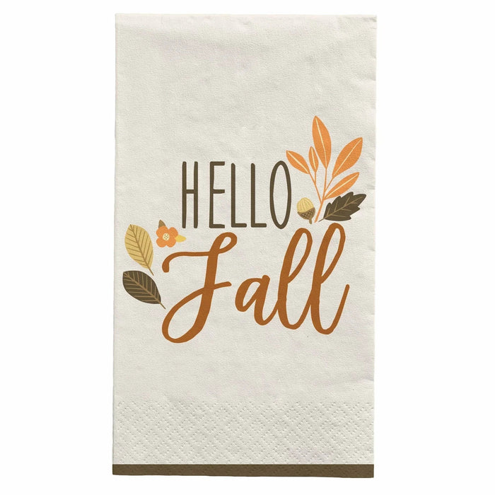 Cream-colored guest towel napkin with "Hello Fall" text in brown and orange script, decorated with autumn leaves and a small flower in warm fall tones.