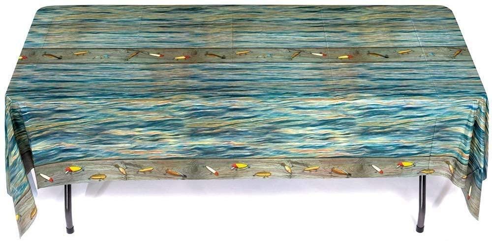 Rectangular tablecloth with blue water wave pattern across the top and bottom borders decorated with colorful fish illustrations, draped over a table with black legs.