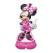 Uninflated foil balloon featuring Minnie Mouse in a pink polka-dot dress with a large pink bow, white gloves, and pink shoes, standing on a pink base.