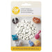 Wilton candy eyeballs package containing white sphere candies with black pupils in a clear dome, surrounded by colorful decorated candy characters including brown bear, black cat, blue cat, pink figure, and gray mouse.