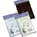 Three rectangular tablecloths in plastic packaging displayed standing up, featuring one black and two white or cream colored covers with decorative floral motifs and size labels indicating 56" x 110".