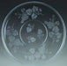 Clear glass serving platter with etched grapevine and leaf design around the outer ring and smaller vine motif in the center well.