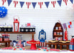 Red, white, and blue pennant banner with alternating striped and star-patterned triangular flags strung across white shiplap backdrop for patriotic decoration.