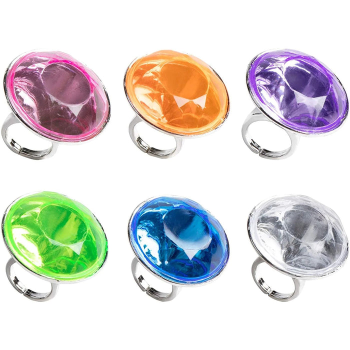 Six colorful plastic rings with large oval gemstone tops in pink, orange, purple, green, blue, and clear, each mounted on a silver-toned band.