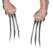 Pair of metallic silver costume claws with four sharp pointed fingers each, held in both hands against a white background.