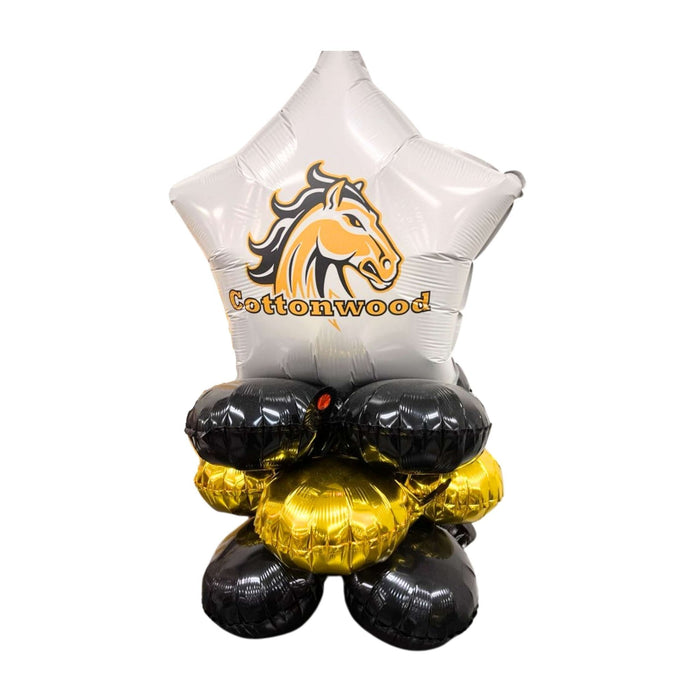 White star-shaped foil balloon topped with a gold and black horse head logo and "Cottonwood" text, sitting atop four black and gold round balloons arranged in a cluster.