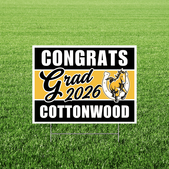 Cottonwood High School graduation yard sign featuring black and gold stripes with a bucking horse logo, reading "Congrats Grad 2026 Cottonwood" on green grass.