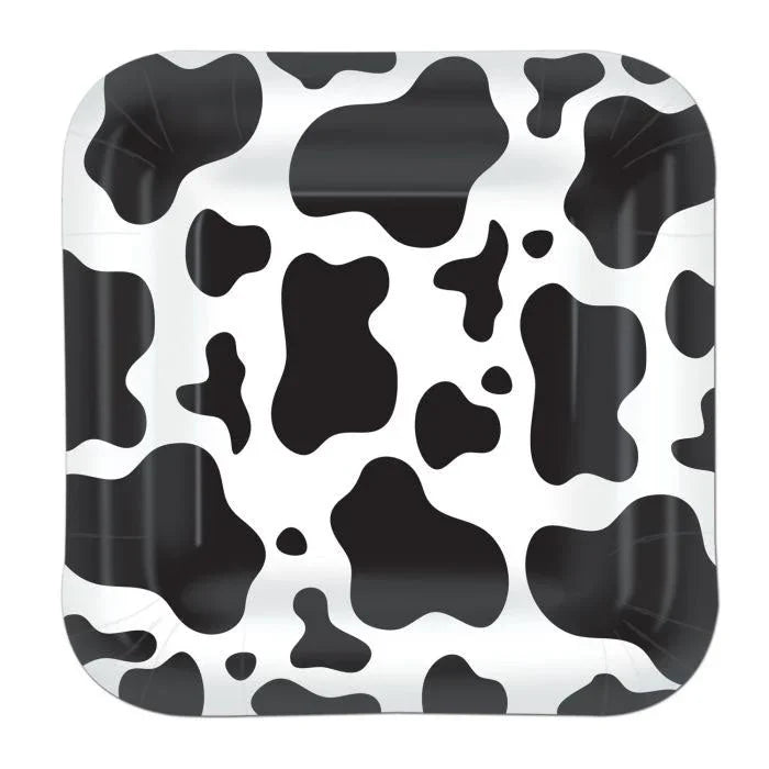 Square white plates with black cow print spots and patches in various sizes throughout the design.