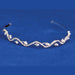 Silver-toned tiara headband with a wavy design, scattered pearl drops, and rhinestone accents throughout, displayed against a blue background.