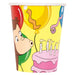 Yellow paper cup featuring Curious George character on the left, a yellow balloon at the top, and a pink birthday cake with lit candles on the right.