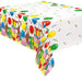 Plastic tablecover featuring Curious George the monkey with colorful balloons, wrapped gifts, and confetti on a white background.