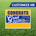 Graduation-themed customizable sign with 'Congrats Grad 2026' on a grass background