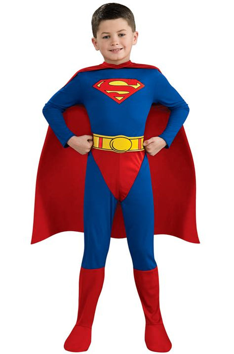 Child wearing a blue and red Superman costume with long sleeves, red cape, yellow belt with circular buckle, and red boots, posing with hands on hips.