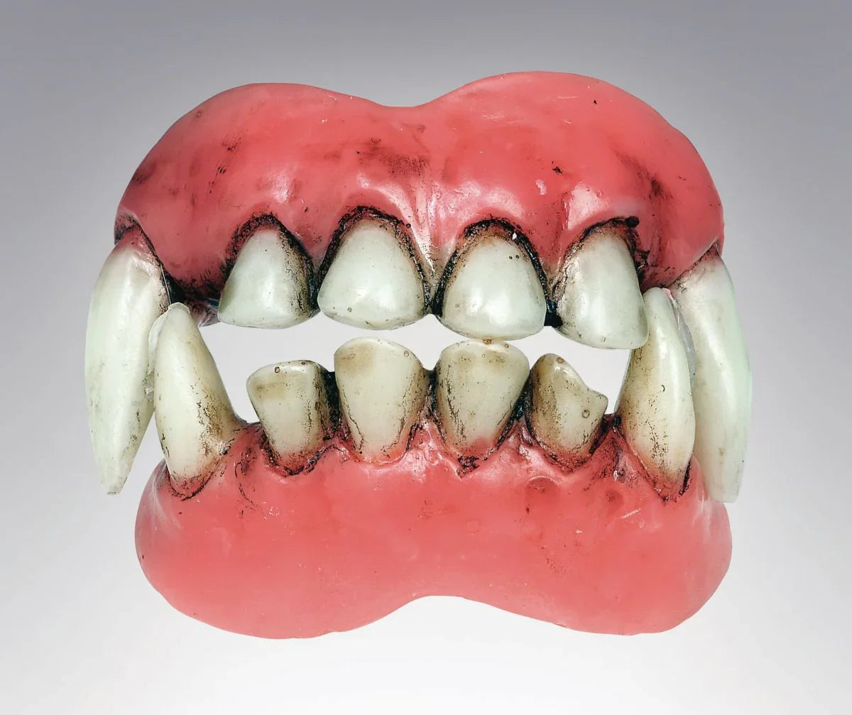 Pair of red and white demon fangs with realistic pointed teeth and dark gum coloring, designed as costume accessory dentures.