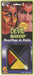 Water-washable devil makeup kit with red, yellow, and black face paint and applicator brush on green and purple packaging.
