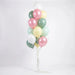 Balloon bouquet featuring pastel pearl pink, sage green, mint, pale yellow, and white latex balloons with curling ribbons.