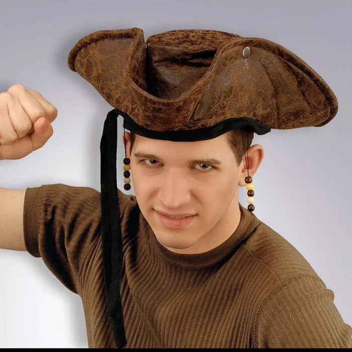 Brown distressed suede pirate hat with black chin strap and decorative beads, displayed on a model wearing a brown ribbed sweater.