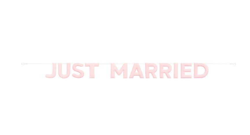 Light pink “Just Married” letter banner displayed on a thin white string.