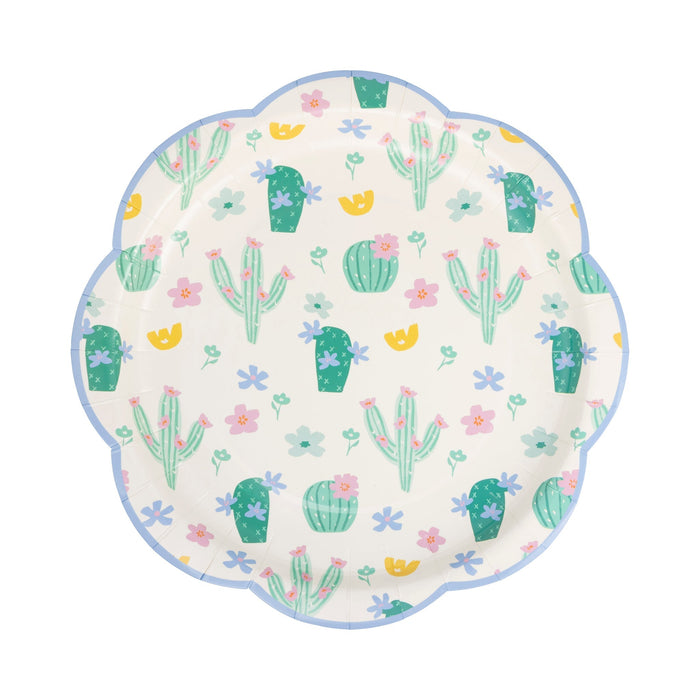 Cream-colored plate with a scalloped blue border featuring a repeating pattern of green cacti, pink and purple flowers, and yellow accents.