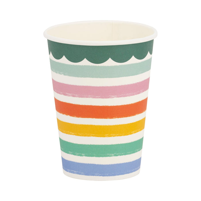 Disposable paper cup with horizontal rainbow stripes in green, teal, pink, orange, yellow, and blue, separated by white bands, featuring a decorative scalloped green rim.