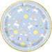 Light blue disposable plate with gold foil rim featuring white unicorns, rainbows, yellow suns, colorful flowers, and gold stars throughout the design.