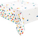 White plastic tablecloth with colorful polka dots in red, yellow, orange, blue, green, and gray scattered across the surface.