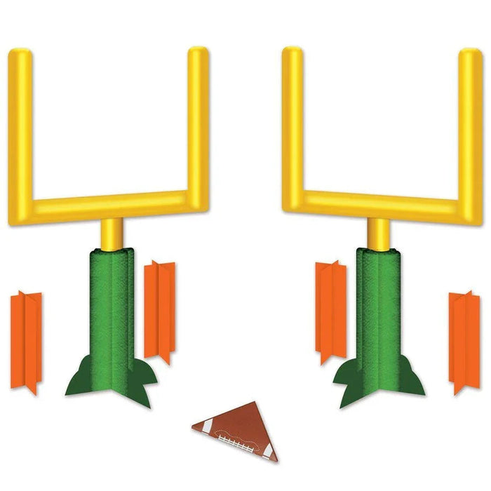 Yellow goal post centerpiece with two green padded bases, orange flag markers on sides, and a brown football at the base.