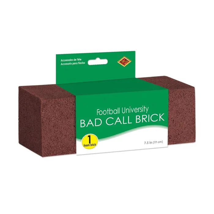 Dark brown foam brick with green packaging labeled "Football University Bad Call Brick" measuring 7.5 inches, containing one foam brick for throwing at bad referee calls.