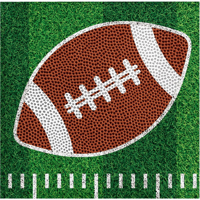 Football-themed beverage napkins with a brown and white football design on green grass background with yard line markings, 16 count.