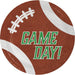 Round brown football-shaped plate with white laces and curved stripes, displaying "GAME DAY!" in green text in the center.