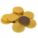 Stack of gold foil-wrapped chocolate coins with one dark brown coin in the center, arranged in a loose pile against a white background.