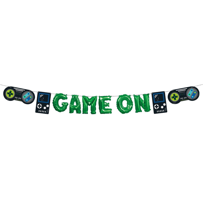 Green "Game On" foil letter banner strung between two black handheld video game controller balloons and two black handheld gaming device balloons on either side.